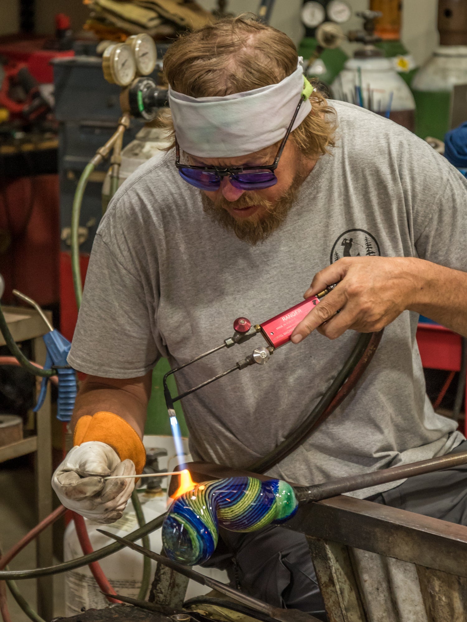 Hopko art glass Michael Hopko working with glass using a torch in a workshop setting