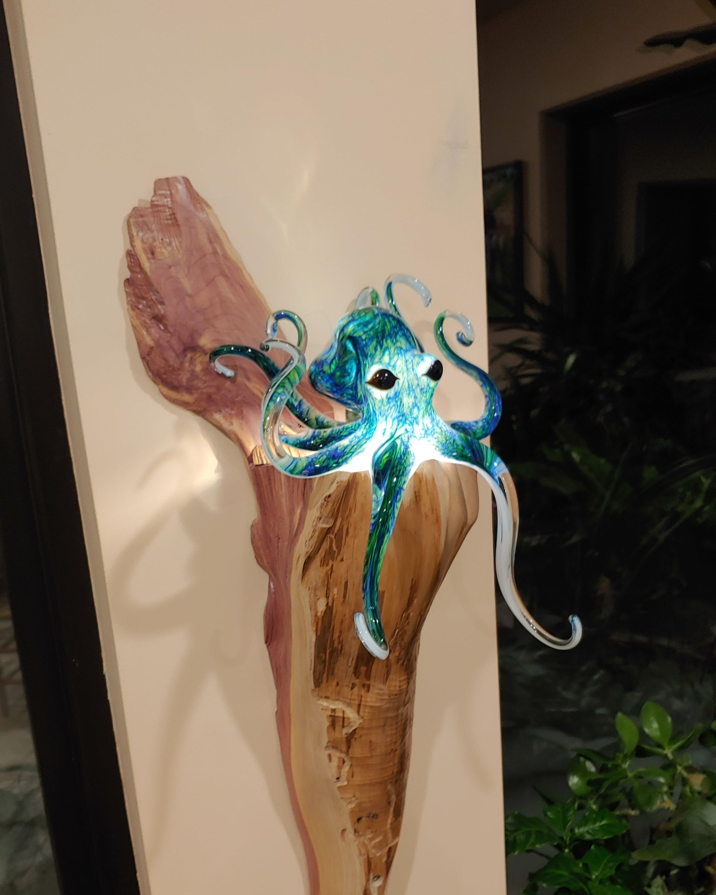 Decorative piece with a stylized octopus design on a wooden surface.
