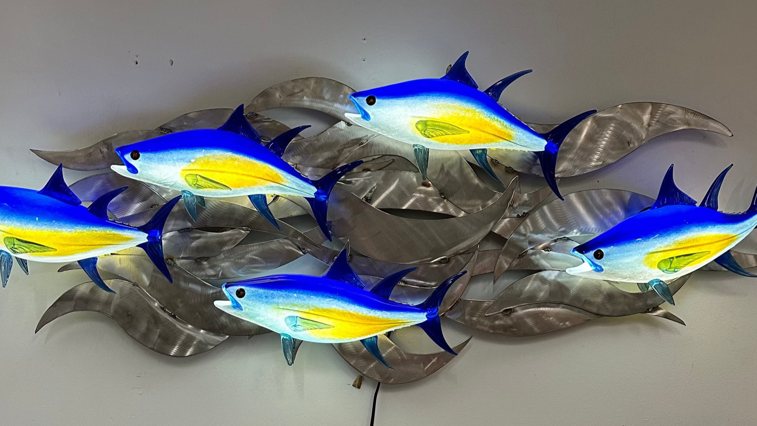 Hopko Art Glass Colorful Glass fish wall art on a plain background