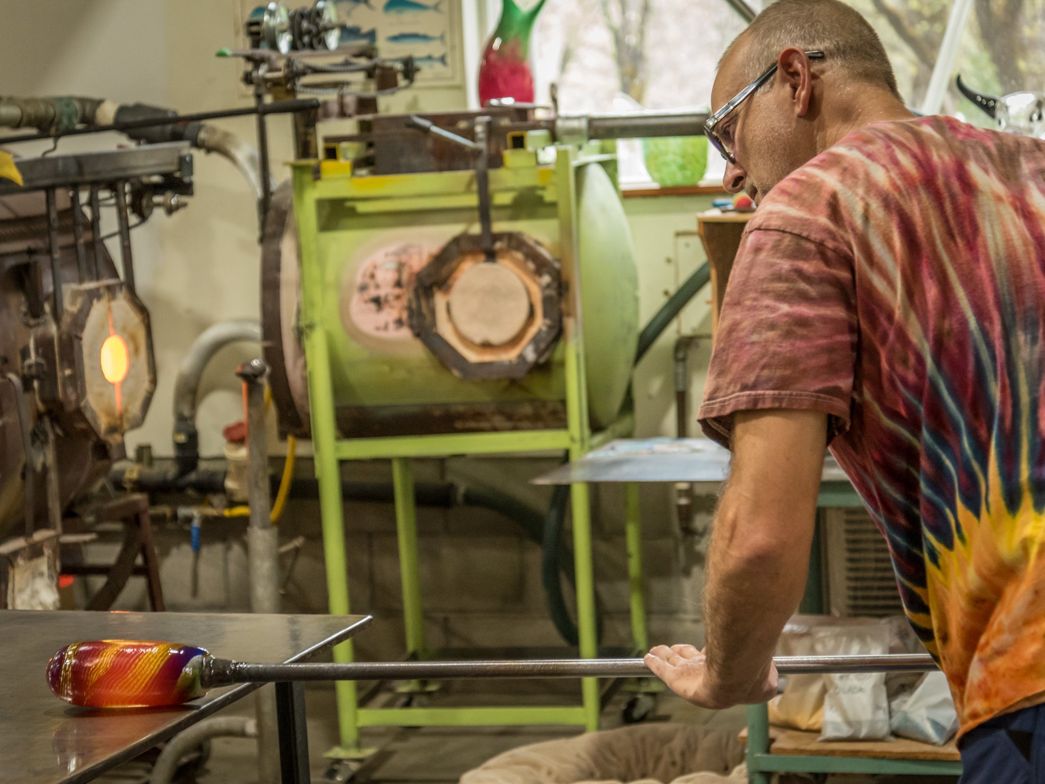 Hopko Art Glass person working with glass in a workshop setting
